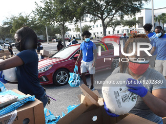Volunteers distribute food and frozen turkeys to the needy donated by the Second Harvest Food Bank of Central Florida and the City of Orland...