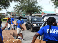 Volunteers distribute food to the needy donated by the Second Harvest Food Bank of Central Florida and the City of Orlando at Jones High Sch...