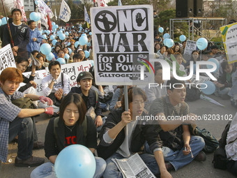 Protester hold pickets a anti-war rally against the South Korean government military dispatch to Iraq at Jongmyo park square in Seoul, South...