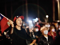 Approximately 1,000 protesters waving the national flag of Taiwan, moving to the beats of music as well as chanting slogans are seen during...