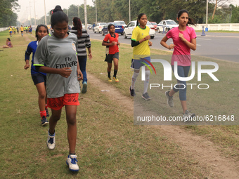 Indian young women Hockey players  maintain social distances  at the practice session Street side ahead Coronavirus pandemic situation in Ko...