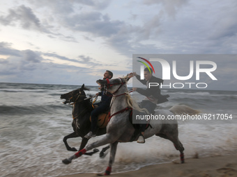 Palestinians ride thier horses on Gaza Beach during sunset, on November 25, 2020. 
 (