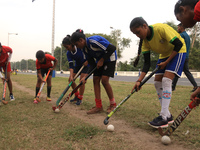 Indian young women players  maintain social distances and  play hockey at the practice session Street side ahead Coronavirus pandemic situat...