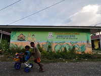 Children playing bicycles at the Temporary Residential Refugee Camp (Huntara), Duyu Village, Tatanga District, Palu City, Central Sulawesi,...