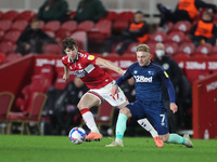 Paddy McNair of Middlesbrough in action with Kamil Jozwiakk during the Sky Bet Championship match between Middlesbrough and Derby County at...