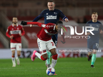 Djed Spence of Middlesbrough battles with Wayne Rooney of Derby County during the Sky Bet Championship match between Middlesbrough and Derby...