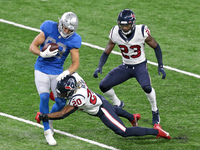 Detroit Lions tight end T.J. Hockenson (88) is tackled by Houston Texans strong safety Justin Reid (20) during the first half of an NFL foot...