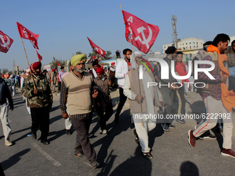 Farmers shout slogans as they protest against the Centre's new farm laws at Singhu border near Delhi, India on November 27, 2020. Farmers fr...