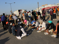 Farmers have meals in a 'Langar' on the blocked road during a protest against the Centre's new farm laws at Singhu border near Delhi, India...