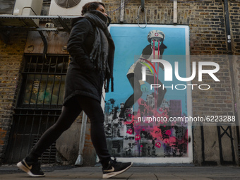 A woman walks by the mural '50 FT HEROES' by the Irish artist Shane Sutton, located in Dublin's city centre.
On Friday, November 27, 2020, i...