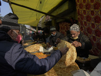 Kashmiri people buy snacks outside Khanyar shirine on the eve of urs of Sheikh Abdul Qadir Jeelani in Srinagar, Indian Administered Kashmir...