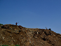 An indian rag-picker searches for recycleable items  at a mountain of garbage dump on the outskirts of Allahhabad  on June 5 ,2015,World Env...