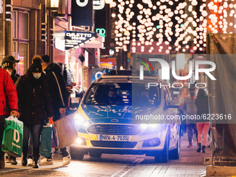 Police car patrols in the shopping block in Cologne, Germany, on November 27, 2020.  (
