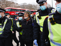 An anti-lockdown activist is arrested at Marble Arch during a demonstration in London, England, on November 28, 2020. London is to return to...