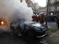 A firefighter tries to put out a car fire in Paris on November 28, 2020 during a protest against the ''global security'' draft law, which Ar...