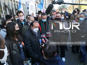 French CGT trade union General Secretary Philippe Martinez (C) speaks to the press on the Place de la Republique in Paris on November 28, 20...