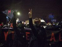 Protesters show V gesture seen during blockade of Warsaw by feminist Womans Strike in Warsaw on November 28, 2020. (
