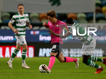 Goncalo Franco of Moreirense FC (C ) vies with Nuno Mendes of Sporting CP (R ) during the Portuguese League football match between Sporting...