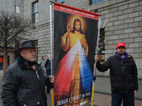Two men hold an image of Jesus Christ during a 'Rosary Rally' outside the GPO on O'Connell Street, on day 39 of the nationwide Level 5 lockd...