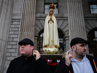 A group of men holds a statue of 'Our Lady' during a 'Rosary Rally' outside the GPO on O'Connell Street, on day 39 of the nationwide Level 5...