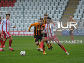 Hull Citys James Scott And Stevenages Remeao Hutton battle for the ball  during the FA Cup match between Stevenage and Hull City at the Lame...