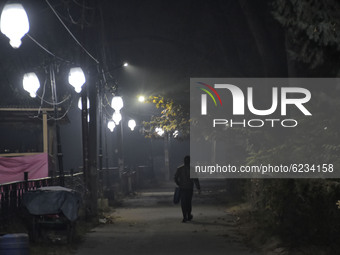 A man walks on a street during cold winter evening in Srinagar, Indian Administered Kashmir on 30 November 2020. (