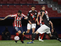 Angel Correa of Atletico Madrid and Javi Martinez of Bayern compete for the ball during the UEFA Champions League Group A stage match betwee...