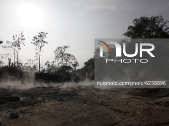 The smoke are seen on Besuk Kobokan river which full of volcanic materials fom the eruption of mount Semeru (3.676 masl) in Sumbersari villa...
