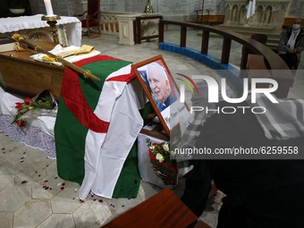 A woman kneels near the coffin of the late Algerian Archbishop Henri Teissier at Notre-Dame d'Afrique cathedral in Algiers on December 9, 20...
