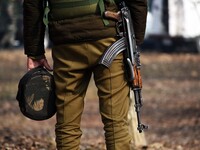 An Indian policeman stands near the gun-battle site in Wanigam Payeen village of north Kashmir's Baramulla district on December 24, 2020. Tw...