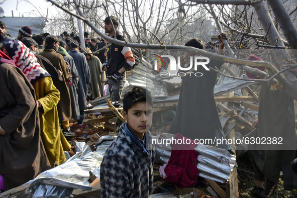 Kashmiri people surround the place where a millitant was killed outside a residential house in Kanigam Village of Shopian district, South of...