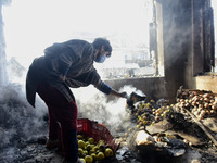 A Kashmiri man  looks for belongings iniside a damaged residential house in Kanigam Village of Shopian district, South of Srinagar, Indian A...