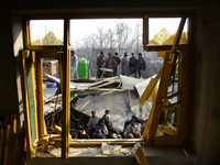 Kashmiri people stand on the debris of a damaged residential house in Kanigam Village of Shopian district, South of Srinagar, Indian Adminis...