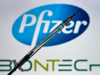 An illustrative image of a medical syringe in front of Pfizer-BionTech logo displayed on a screen.
On Monday, December 28, 2020, in Dublin,...