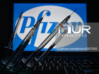 An illustrative image of medical syringes seen in front of Pfizer logo displayed on a screen.
On Monday, December 28, 2020, in Dublin, Irela...