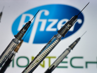 An illustrative image of medical syringes seen in front of Pfizer-BionTech logo displayed on a screen.
On Monday, December 28, 2020, in Dubl...