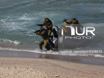 Armed fighters take part in a military drill by Hamas and other Palestinian armed factions on a beach in Gaza City on December 29, 2020.
 (