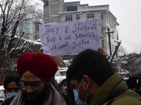 A man holds a placard during protest against the killing of three alledged local militants by Indian forces in Srinagar, Indian Administered...