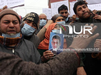 Family members of the youth killed in Lawaypora encounter stage protest in Srinagar on January 04, 2021 and demanded the bodies of their war...