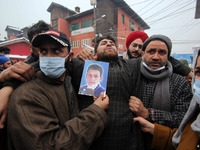 Father of Athar Mushtaq (C) felt unconcious while staging protest in Srinagar on January 04, 2021 and demanded the bodies of their wards .Pe...