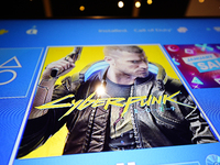 The Cyberpunk game is seen being installed on a Playstation 4 console in Warsaw, Poland on January 5, 2021. Cyberpunk 2077 was hailed as the...