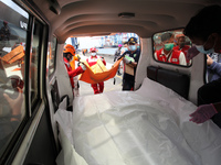 Officers lift the bag containing human remains of Sriwijaya Air passengers to the ambulance and will be taken to the National Police Hospita...