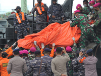 The officers lifted bag containing debris of the Sriwijaya Air plane which had just been unloaded from the Indonesian Navy ship on January 1...