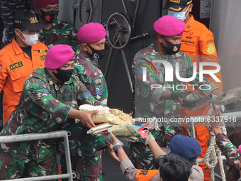 The officers lifted debris of the Sriwijaya Air plane which had just been unloaded from the Indonesian Navy ship on January 10, 2021. The pl...