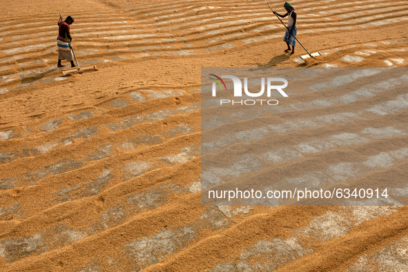 People work in a rice processing mill in Munshiganj, Bangladesh January  11, 2021 