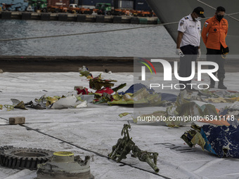 Search and rescue personnel show debris from the Sriwijaya Air plane that crash at Tanjung Priok Port on January 11, 2021 in Jakarta, Indone...