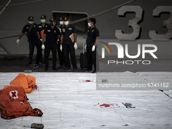 Search and rescue personnel show debris from the Sriwijaya Air plane that crash at Tanjung Priok Port on January 11, 2021 in Jakarta, Indone...