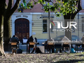 Italian students study with computers and books outside the Calini's High School in Brescia, Italy, on January 11, 2021 during a demonstrati...