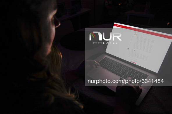 A woman is seen surfing the Parler website on a laptop in this photo illustration in Warsaw, Poland on January 11, 2021. The Parler app, dev...