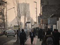 Iranian people walk along a street-side in western Tehran during a polluted air, following the COVID-19 outbreak in Iran, on January 12, 202...
